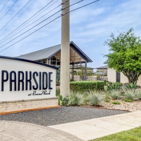 Settle into comfort at Parkside at Round Rock a sign on a sidewalk