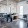 a clubhouse room with desks, chairs and windows