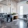 a clubhouse room with desks, chairs and windows