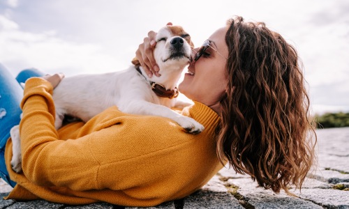 girl petting her dog