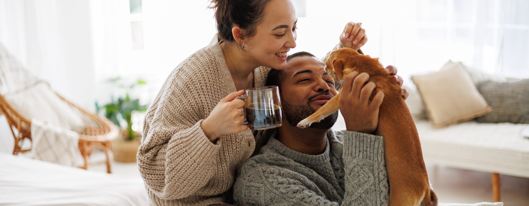 man and a woman with their pet cat