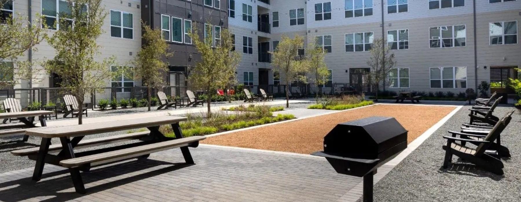 a group of tables and chairs outside of a building