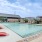 a swimming pool with lounge chairs around it