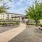 a courtyard with picnic tables and trees