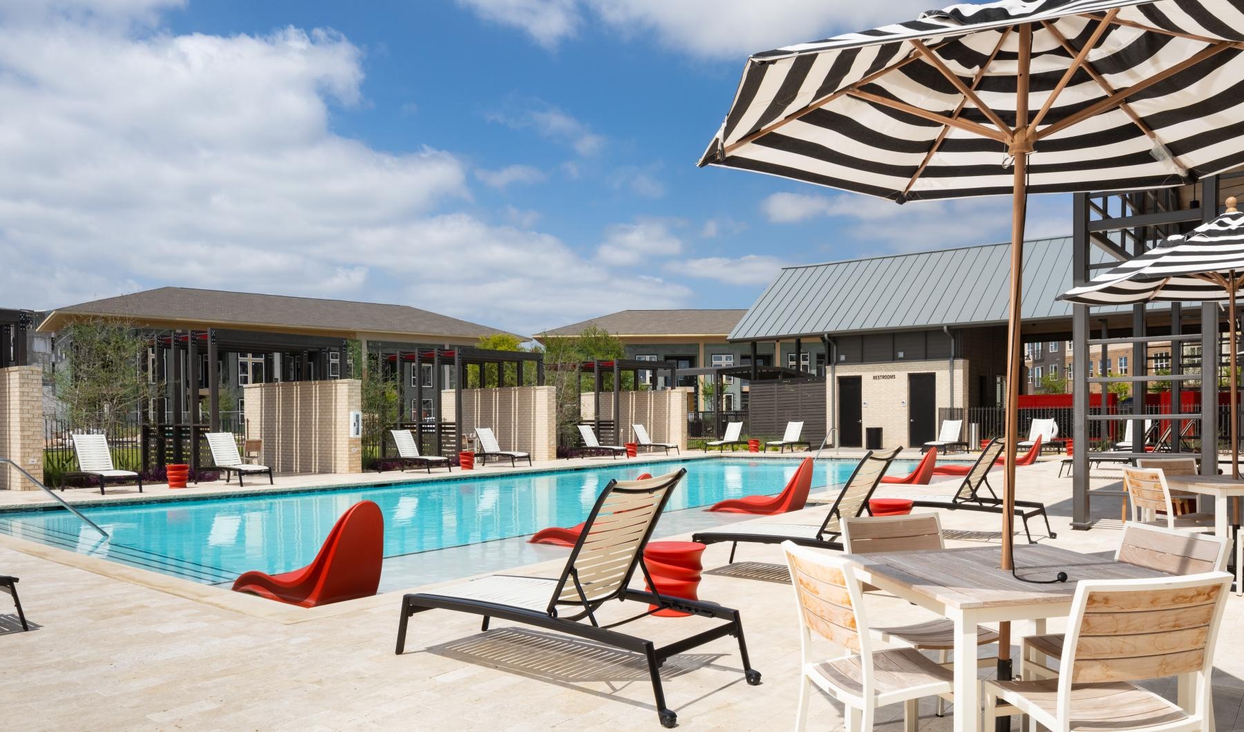 a pool with chairs and umbrellas