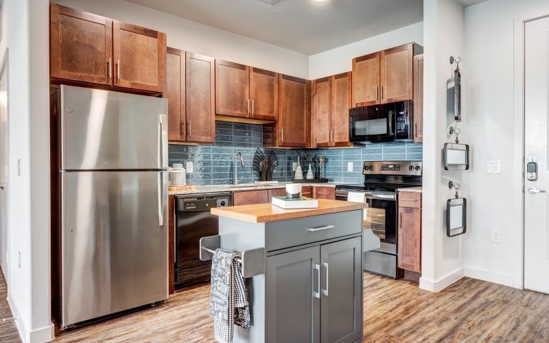 a kitchen with wooden cabinets